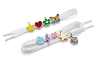 Decorative shoelace charms fitted to white shoelaces